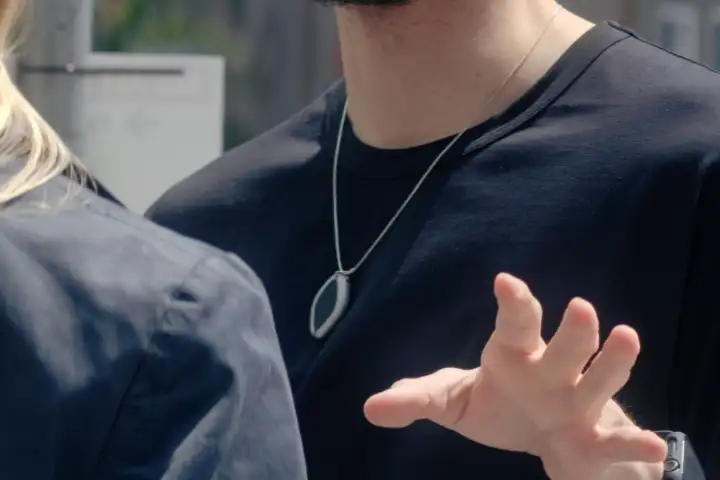 person wearing AI friend device as a necklace Person Wearing Ai Friend Device as A Necklace