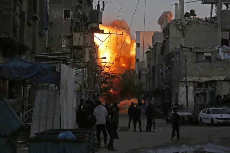 Smoke rises from a building destroyed by Israeli airstrike at the Bureij camp Smoke rises from a building destroyed by Israeli airstrike at the Bureij camp